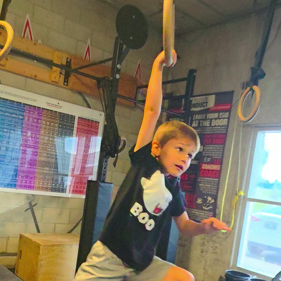 A ninja swinging across the rings
